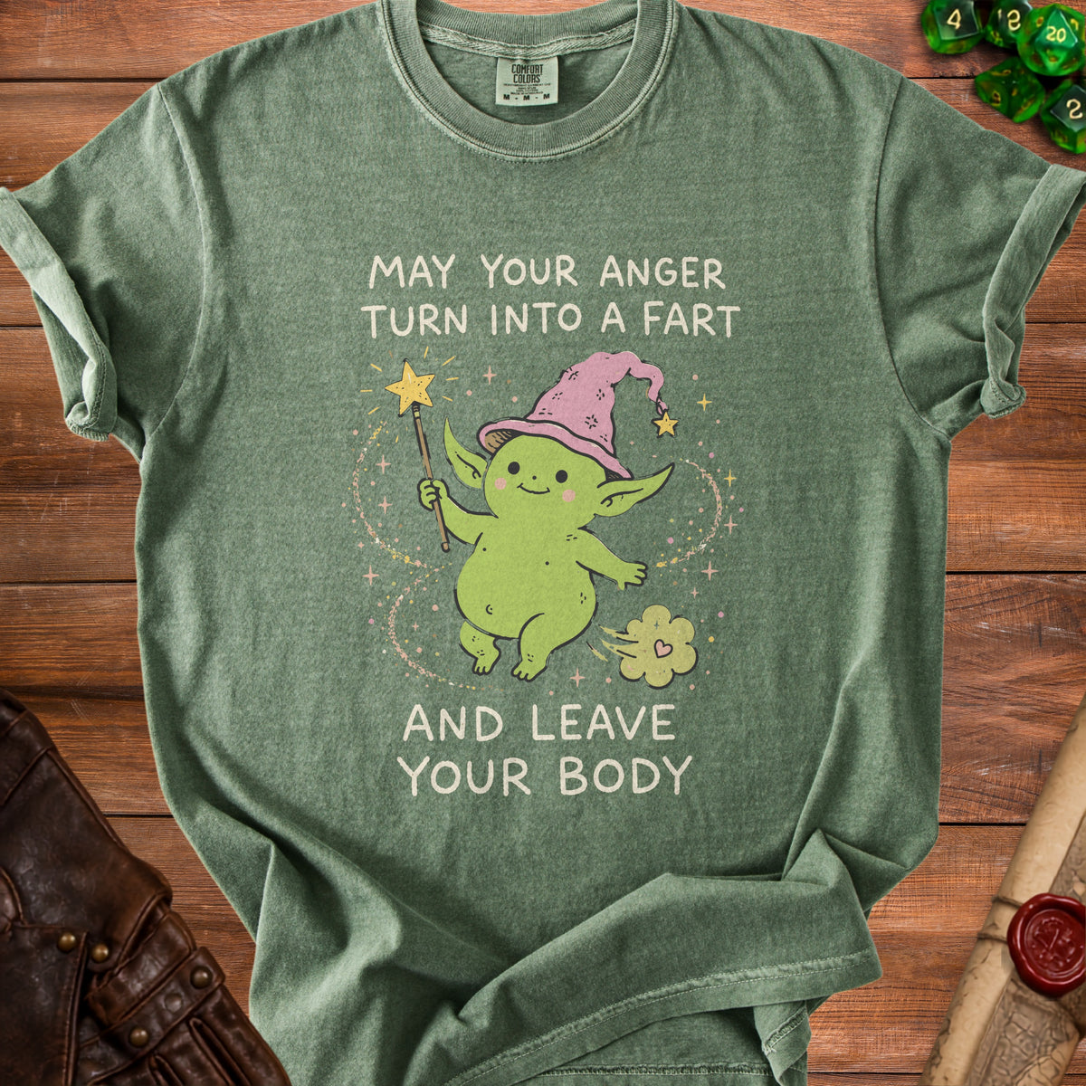 Green t-shirt with a cartoon goblin casting a fart spell with text "May Your Anger Turn Into A Fart And Leave Your Body".