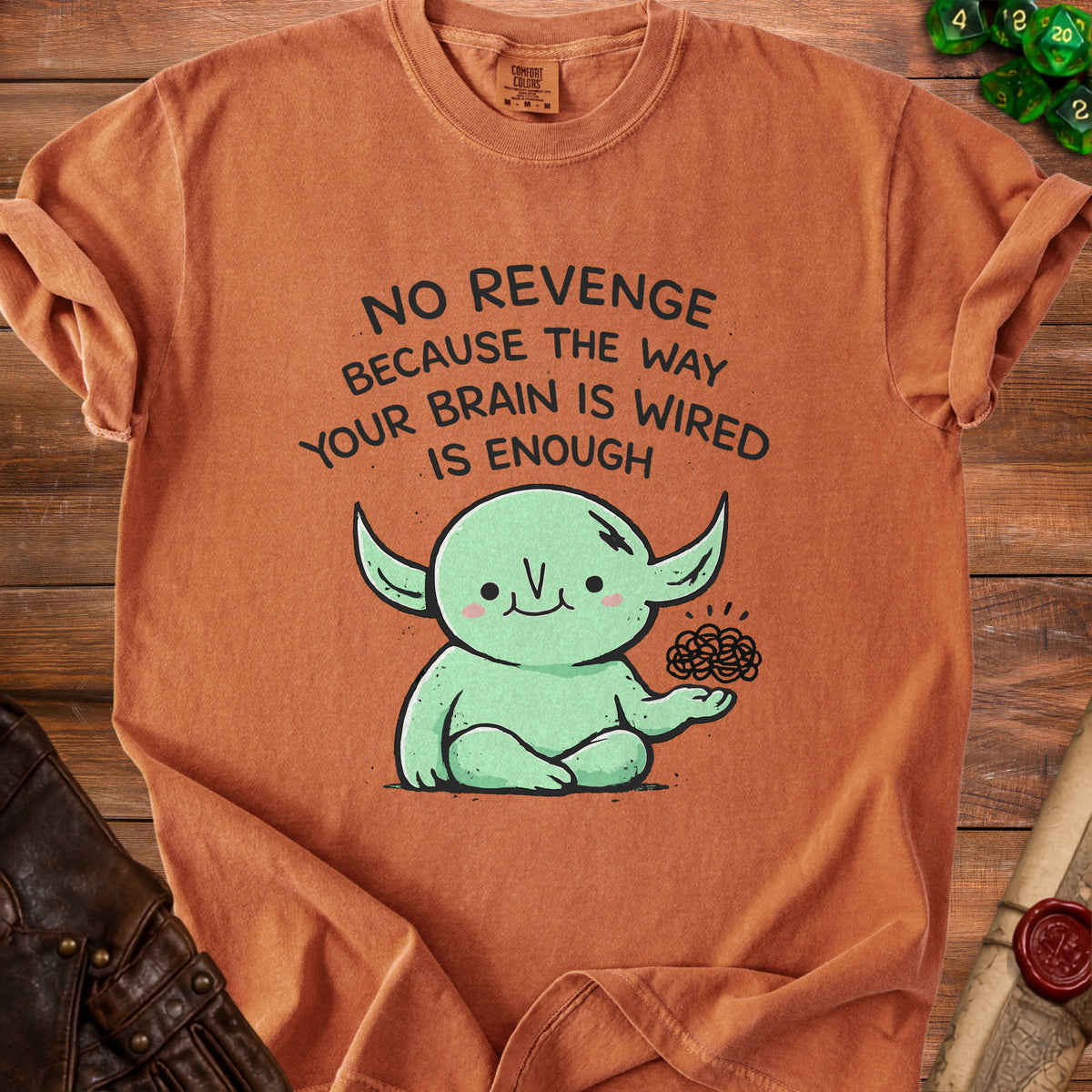 Orange t-shirt with "No Revenge Because The Way Your Brain Is Wired Is Enough" and a cartoon creature.