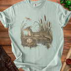 Dragon by reeds with dragonfly and d20 dice.