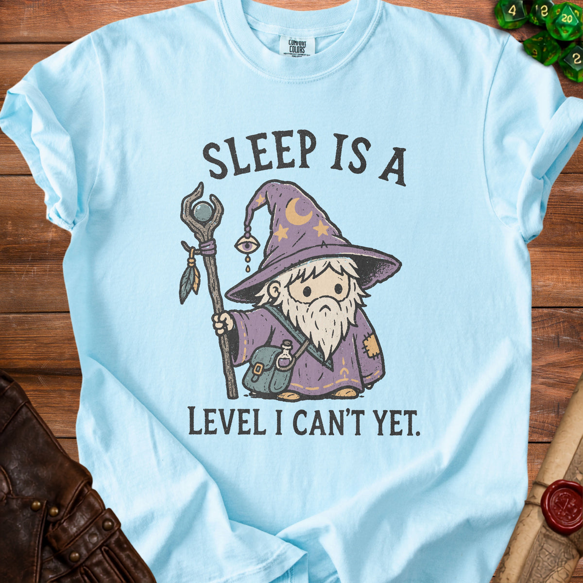 Light blue t-shirt with graphic of a wizard saying "Sleep is a Level I Can't Yet."