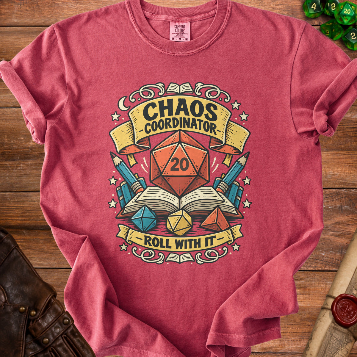 Red t-shirt with "Chaos Coordinator - Roll With It" and D20 dice graphic.