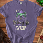 Purple t-shirt with "Master of Fate" text and a goblin puppet master controlling fantasy characters.