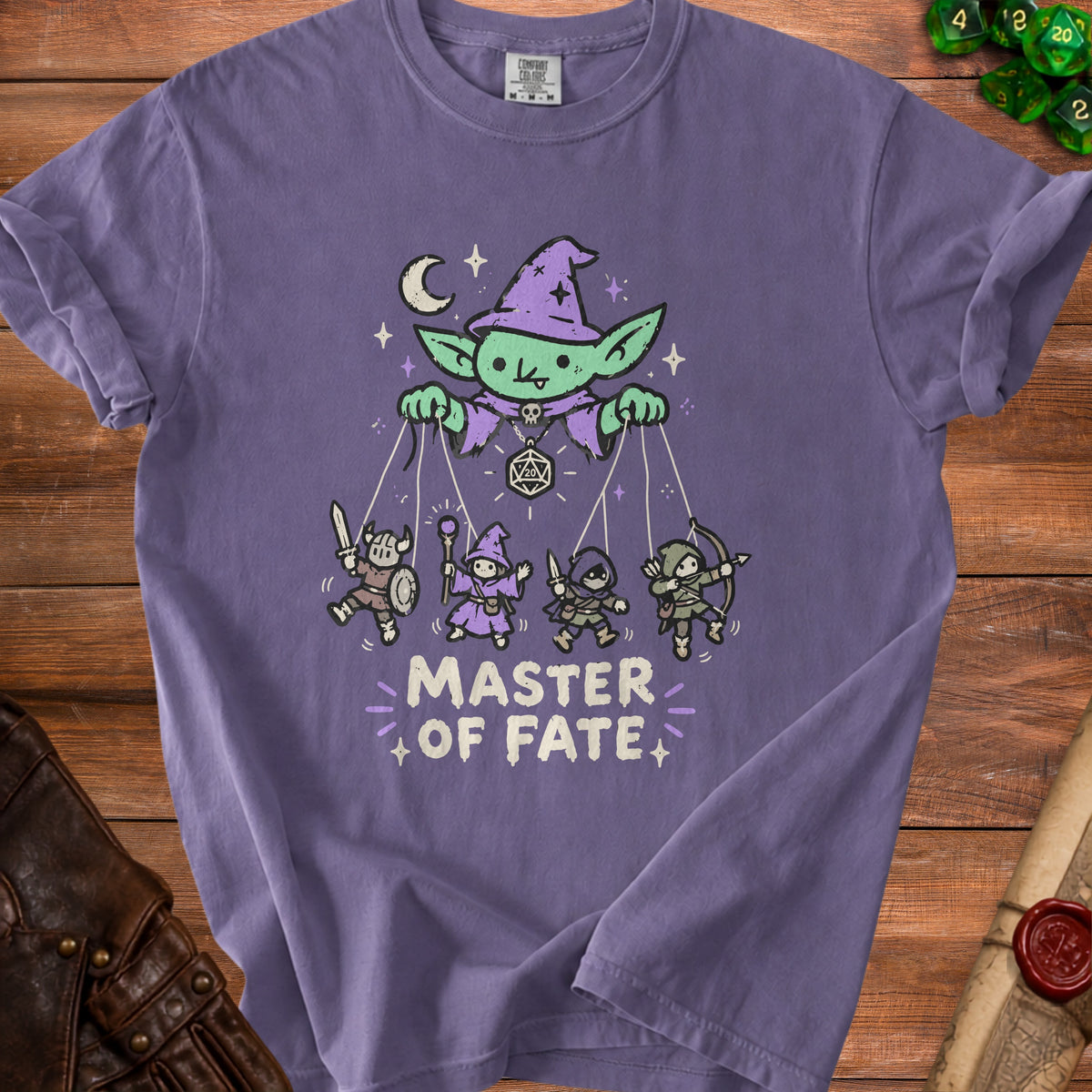 Purple t-shirt with "Master of Fate" text and a goblin puppet master controlling fantasy characters.