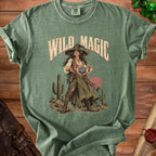 Green t-shirt with "Wild Magic" text and an illustration of a witch holding a D20 die.