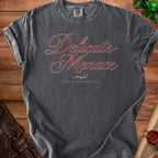 Dark grey t-shirt with "Delicate Menace raised by questionable magic" text.