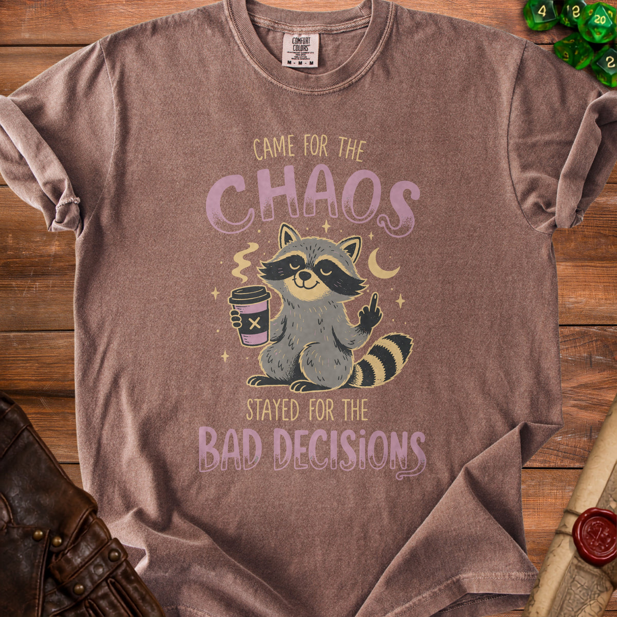 Brown t-shirt with a graphic of a raccoon holding coffee and the text "Came for the Chaos, Stayed for the Bad Decisions".