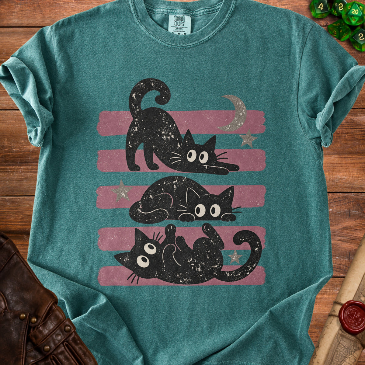 Three black cats with wide eyes on a striped background with stars and a moon.