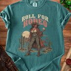 T-shirt with "Roll for Rodeo" text featuring a demon cowgirl holding a d20 dice.