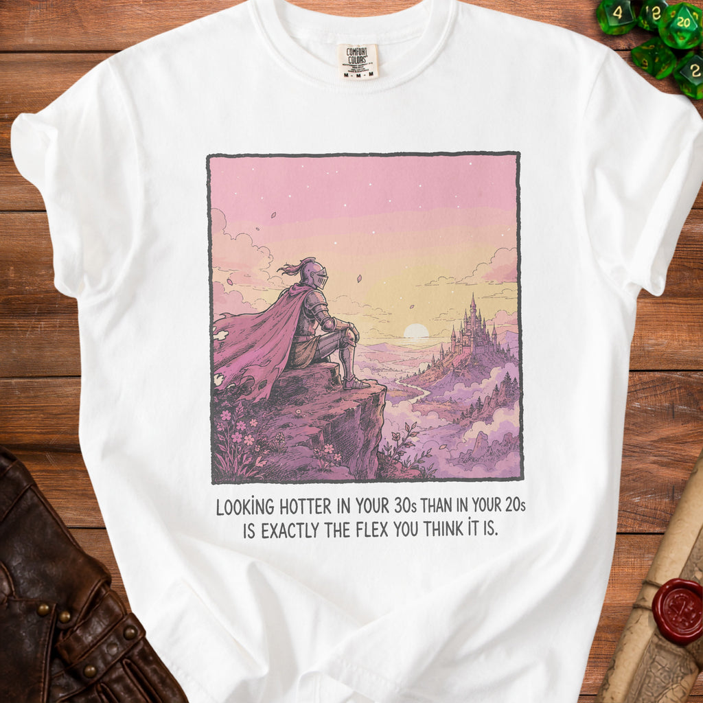White t-shirt with knight illustration and text "Looking hotter in your 30s than in your 20s is exactly the flex you think it is."