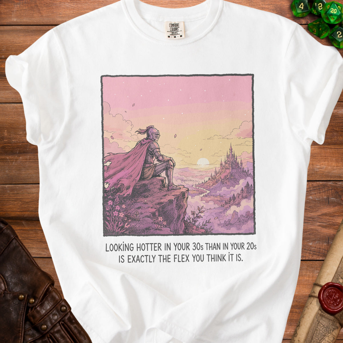 White t-shirt with knight illustration and text "Looking hotter in your 30s than in your 20s is exactly the flex you think it is."
