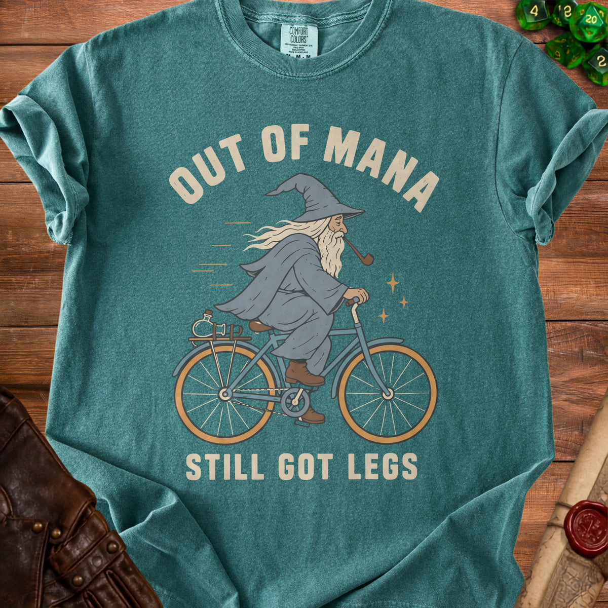 Teal t-shirt with wizard on bicycle saying "Out of Mana, Still Got Legs".