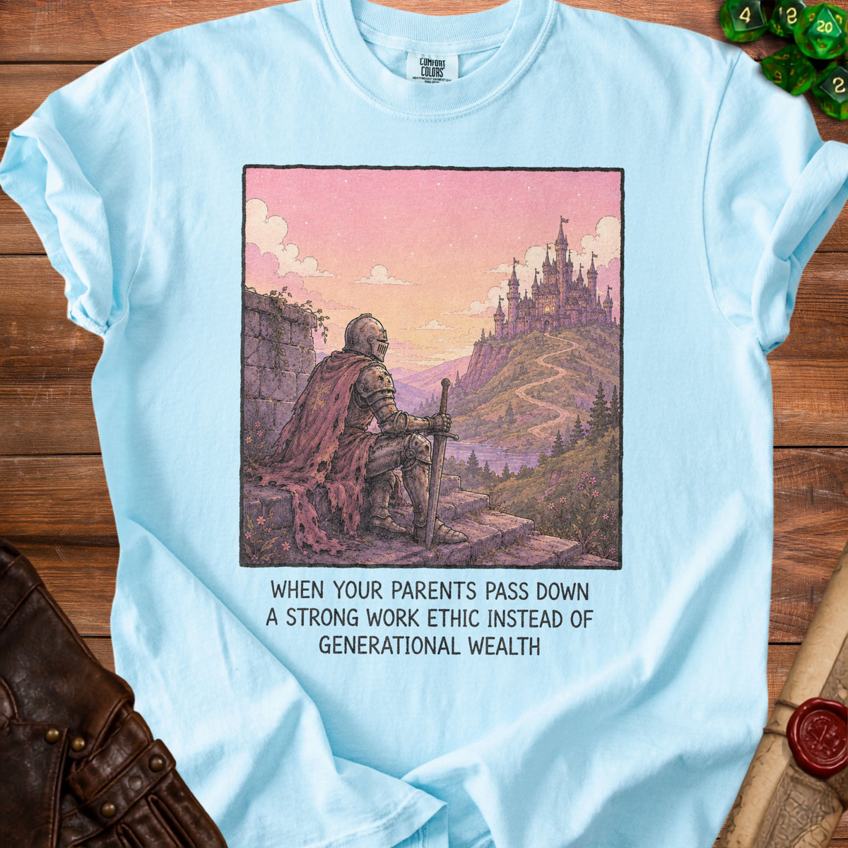 Light blue t-shirt with knight looking at castle, text about work ethic and wealth.