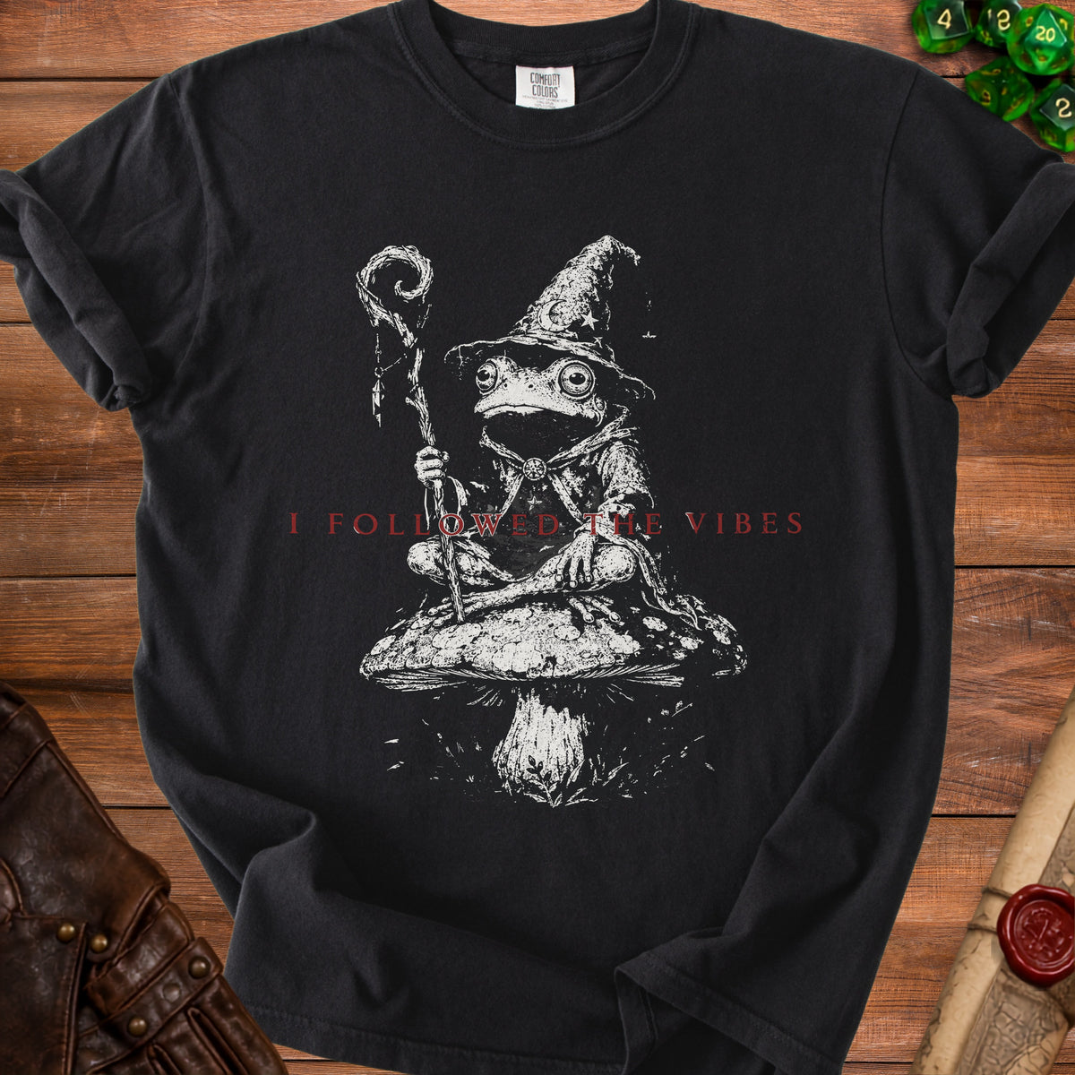 Black t-shirt with wizard frog on mushroom graphic and text "I FOLLOWED THE VIBES."