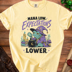 Yellow t-shirt with wizard frog graphic and text "Mana low, expectations lower".