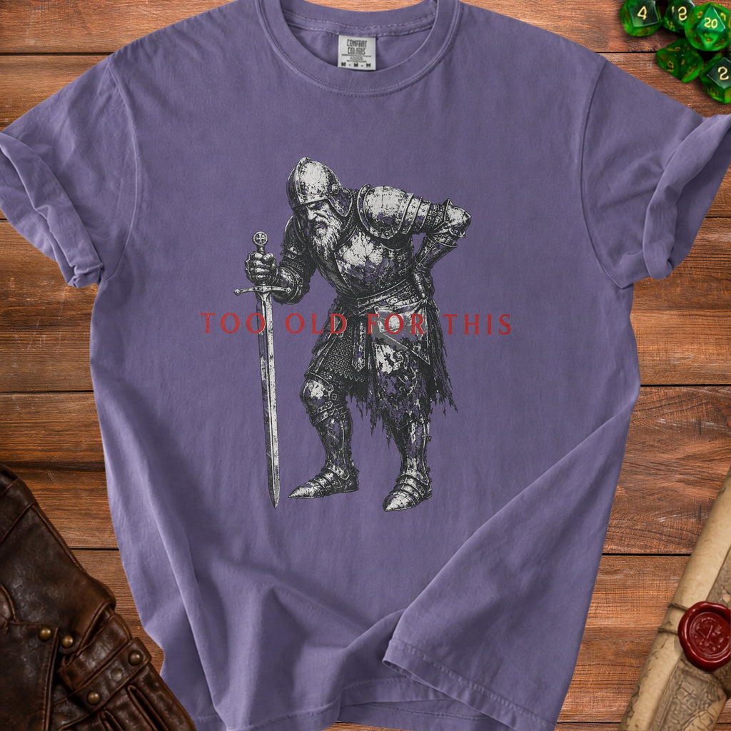 Purple t-shirt with graphic of a weary knight holding a sword and text "Too Old For This".