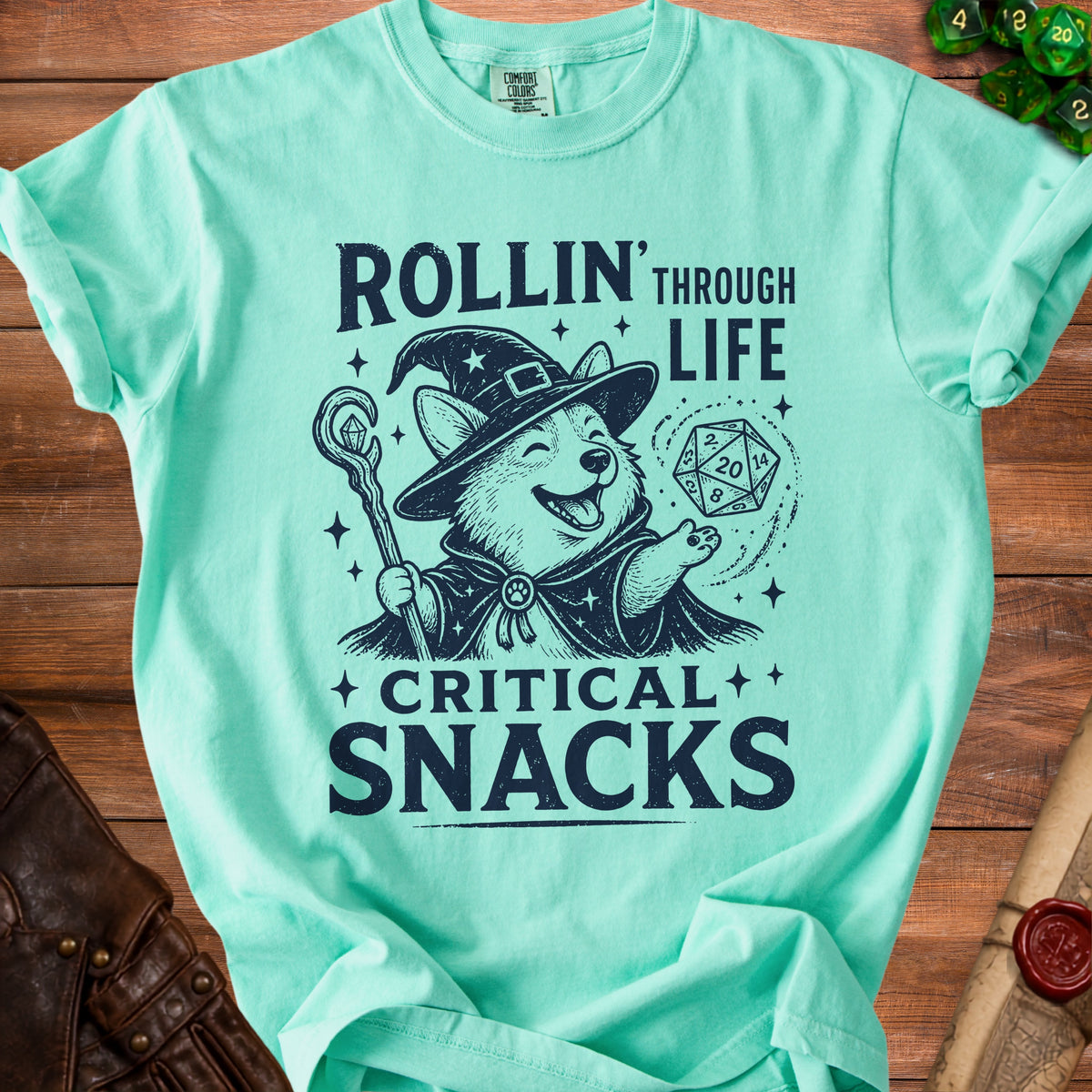 Corgi wizard with dice and staff on a shirt reading "Rollin' Through Life Critical Snacks".