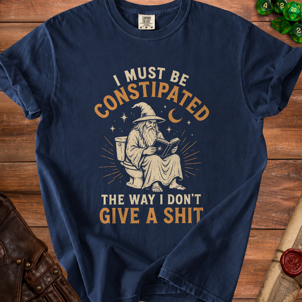T-shirt graphic with wizard on toilet reading, text: "I MUST BE CONSTIPATED THE WAY I DON'T GIVE A SHIT."