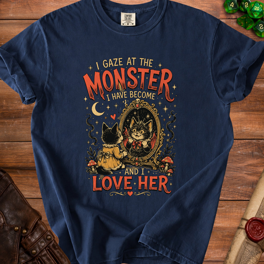 Dark blue t-shirt with "I gaze at the monster I have become and I love her" text and cat art.