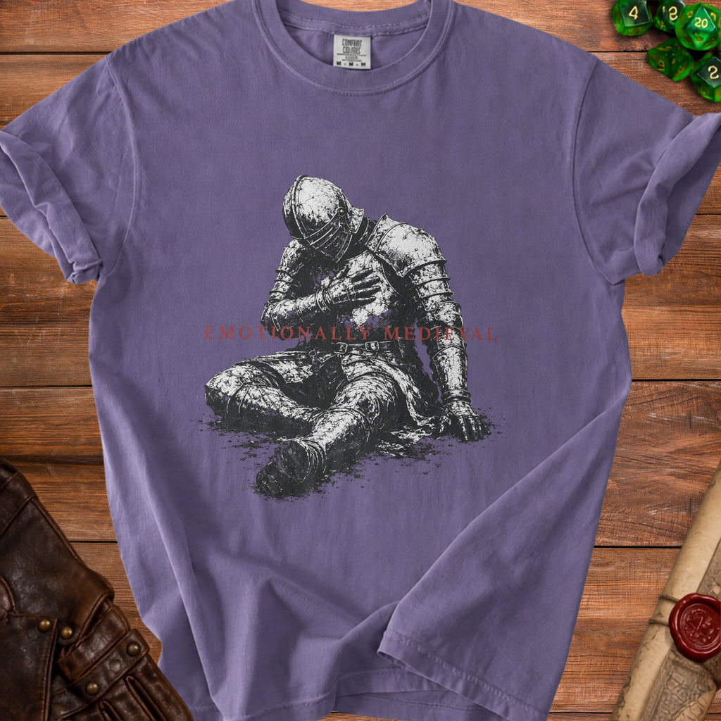 Purple t-shirt with distressed knight graphic and text "Emotionally Medieval".