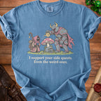 Blue shirt with knight watering a mushroom and a wizard, text reads "I support your side quests. Even the weird ones."