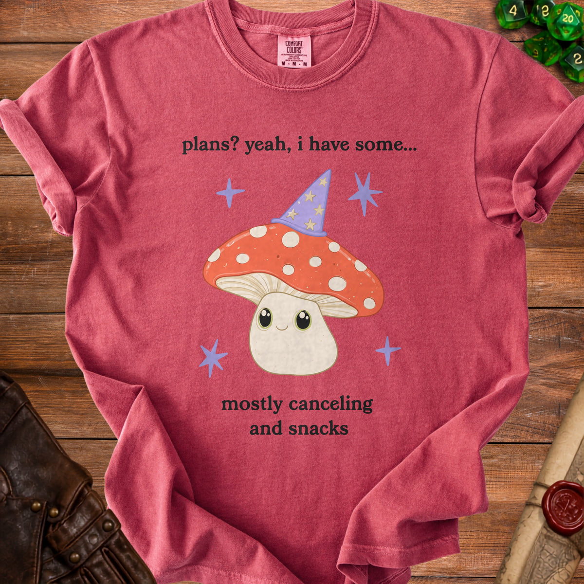 Red t-shirt with a cartoon mushroom wearing a wizard hat and the text "plans? yeah, i have some... mostly canceling and snacks."