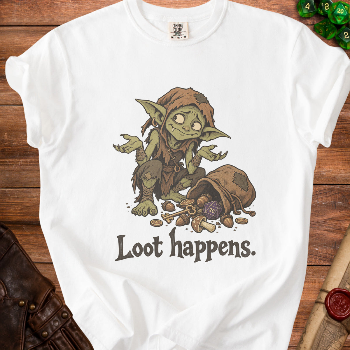White t-shirt with goblin, dice, key, and "Loot happens." text graphic.