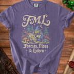 Purple t-shirt with FML and a goblin reading among forests, moss, and lichen.