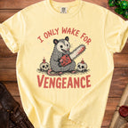 Yellow t-shirt with opossum holding chainsaw, text reads "I only wake for vengeance."