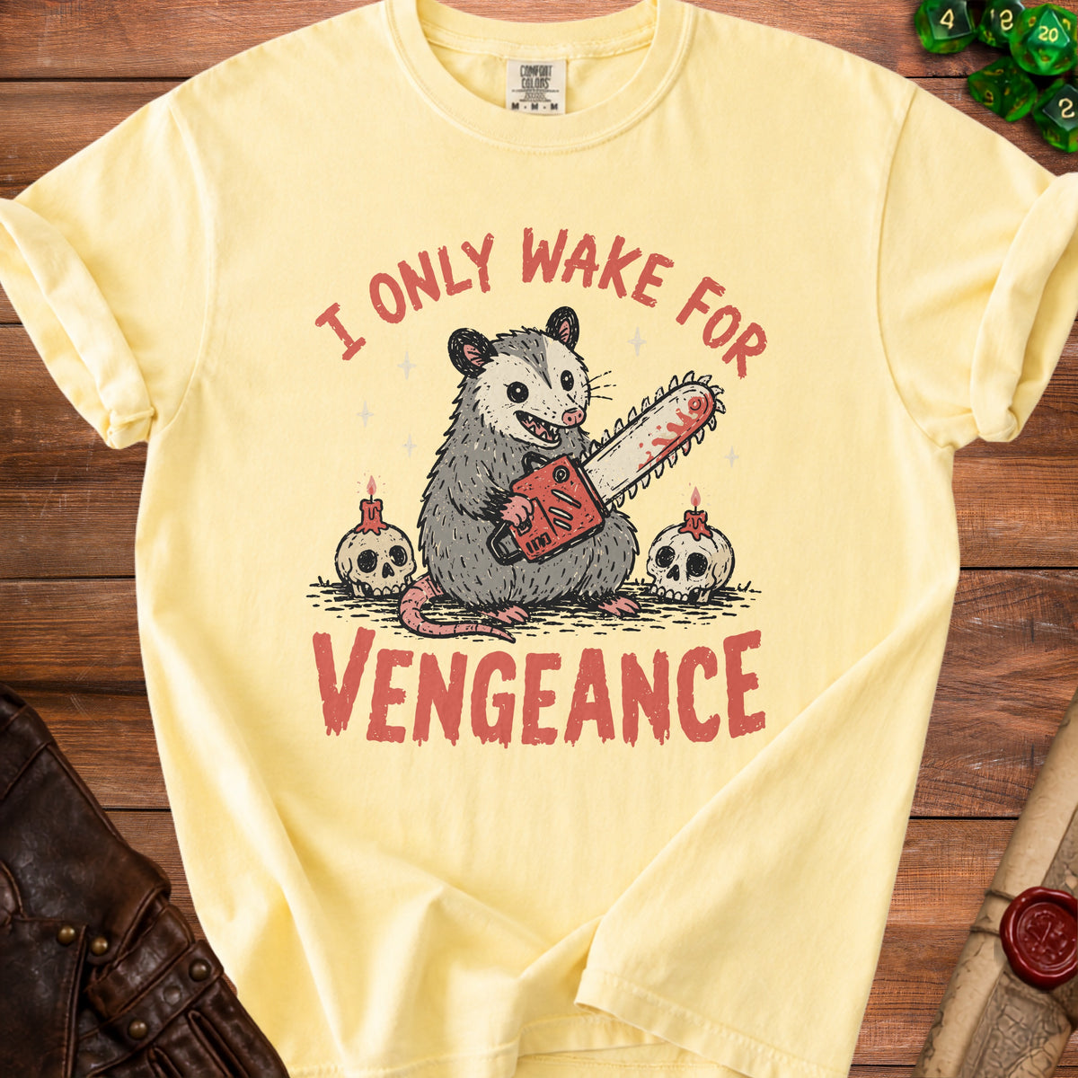Yellow t-shirt with opossum holding chainsaw, text reads "I only wake for vengeance."