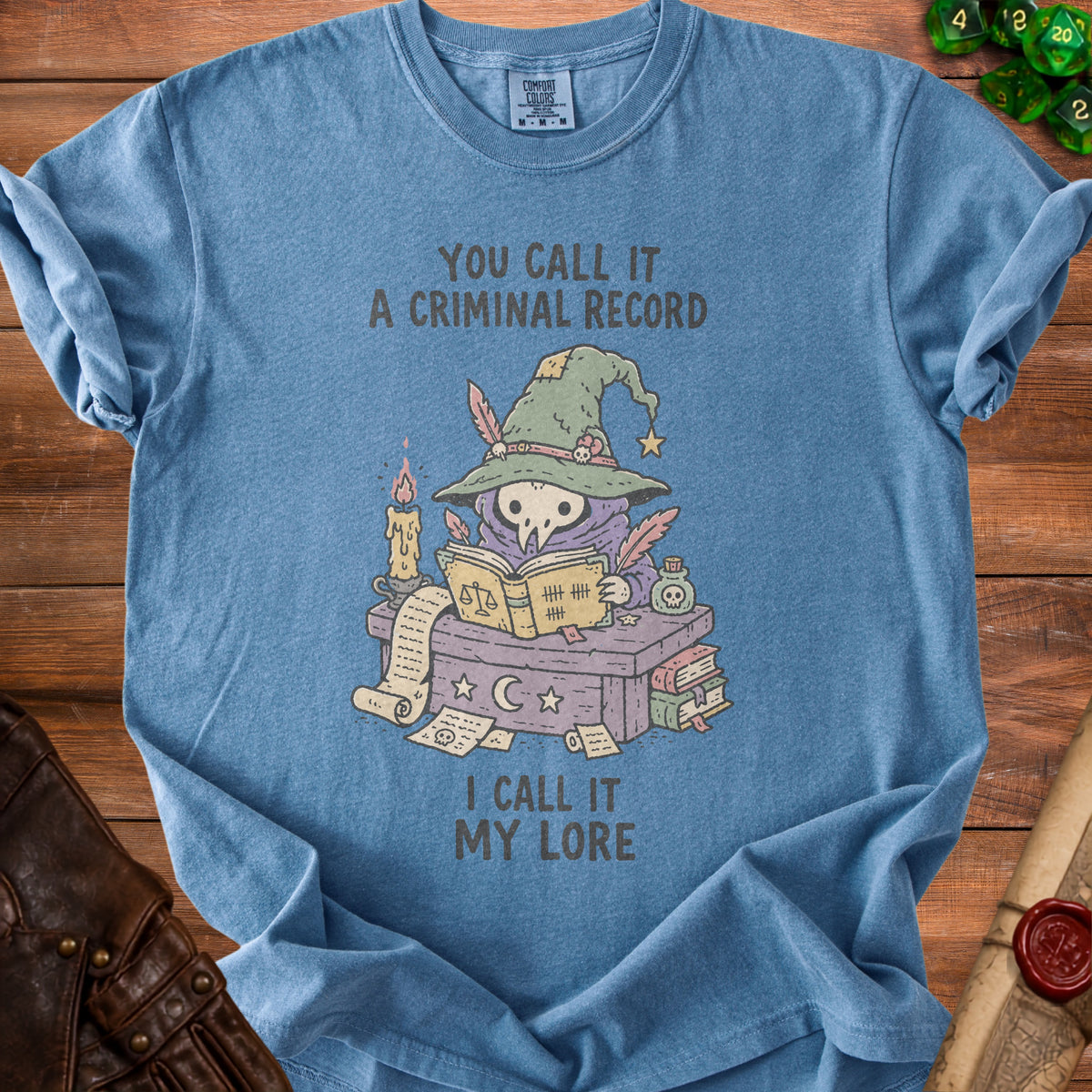 Blue t-shirt with cartoon plague doctor wizard, text "You call it a criminal record, I call it my lore".