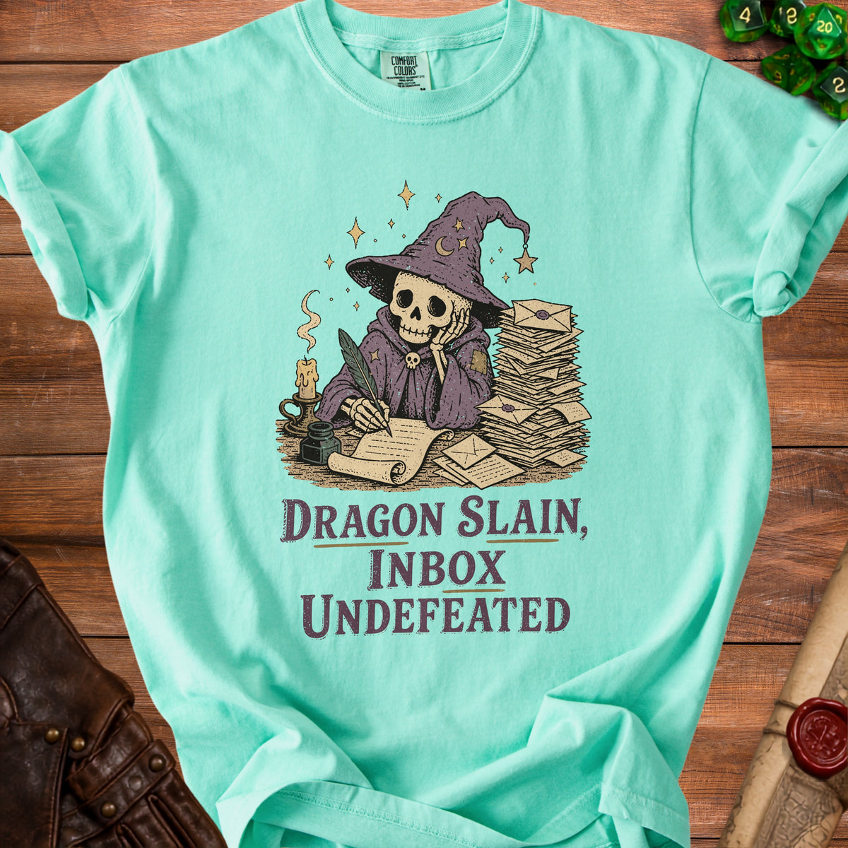 Mint green t-shirt with skeleton wizard graphic and text "Dragon Slain, Inbox Undefeated".