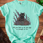 Mint green t-shirt with grumpy cat tangled in yarn and knitting needles.
