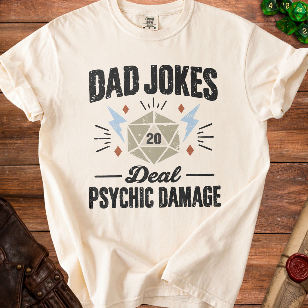 Cream t-shirt with "Dad Jokes Deal Psychic Damage" text and D20 dice graphic.