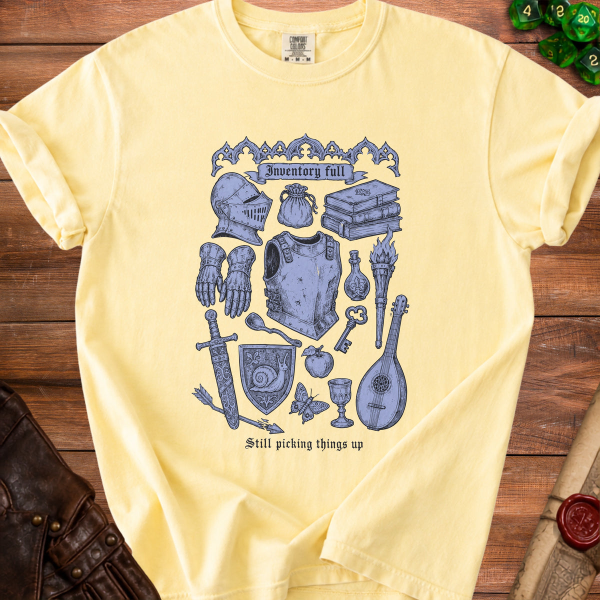 Yellow t-shirt with blue medieval fantasy inventory items and text.