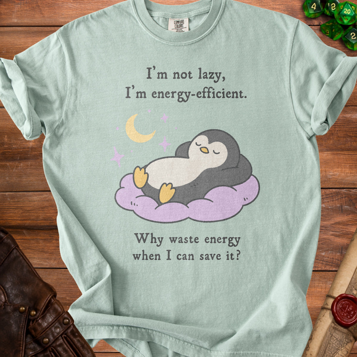 Light green t-shirt with text and cartoon penguin resting on a cloud.