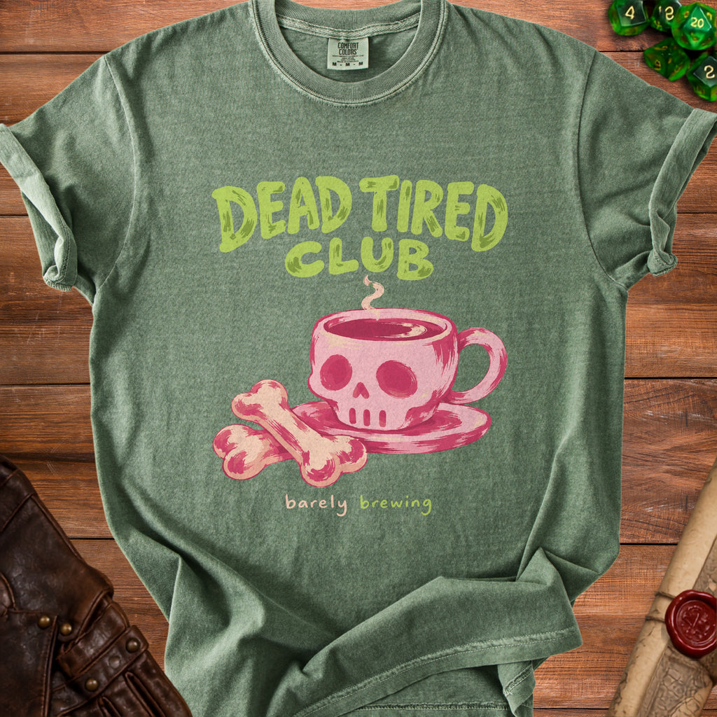 Green t-shirt with "Dead Tired Club barely brewing" text and skull coffee cup graphic.