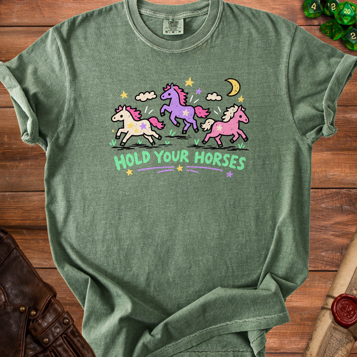 Green t-shirt with three cartoon horses and the text "HOLD YOUR HORSES".