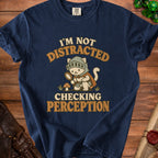 Navy t-shirt with a knight cat holding a magnifying glass and text "I'm not distracted checking perception."