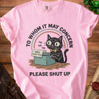 Pink t-shirt with a black cat typing "PLS STFU" on a typewriter, with text.