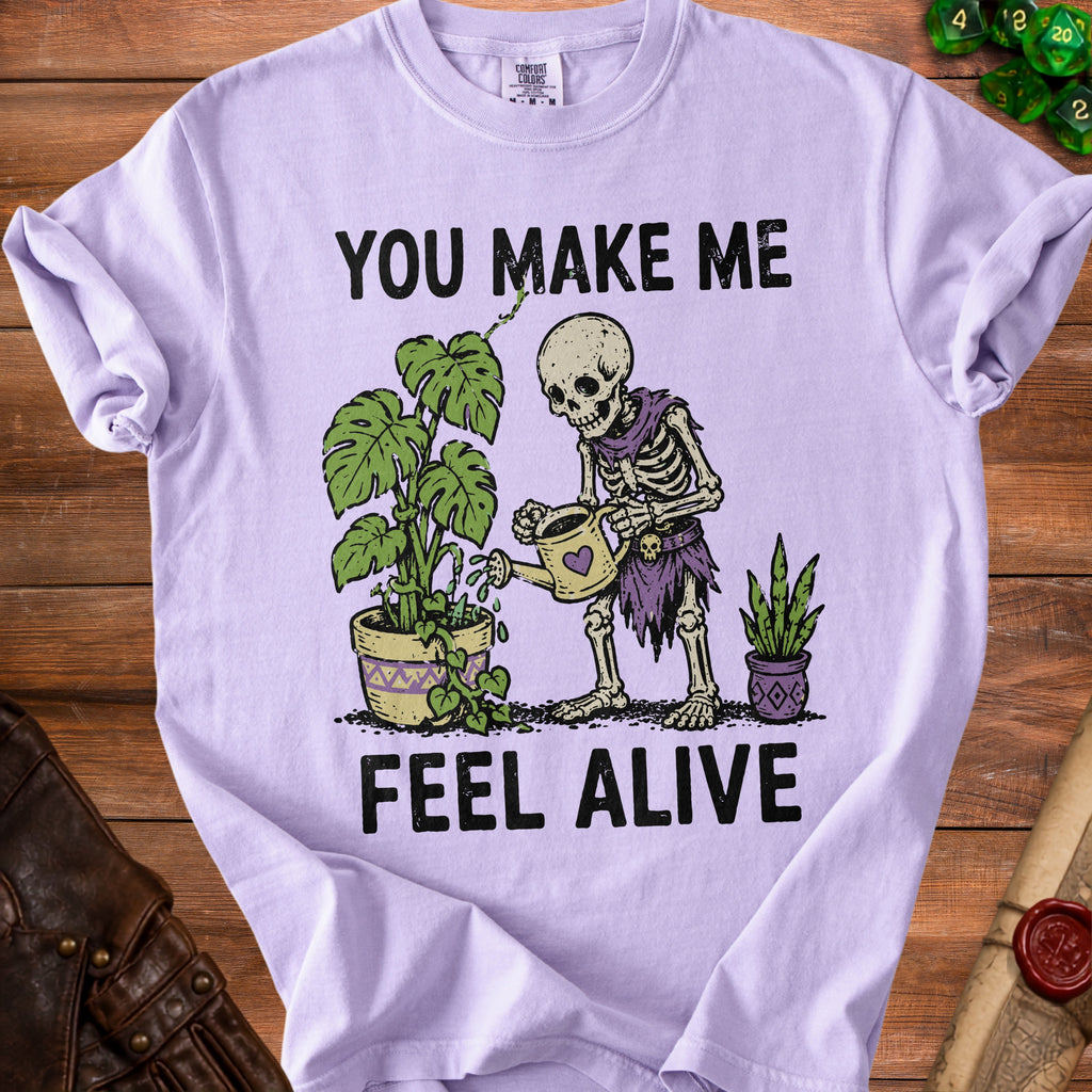 Skeleton watering plants with text "YOU MAKE ME FEEL ALIVE".