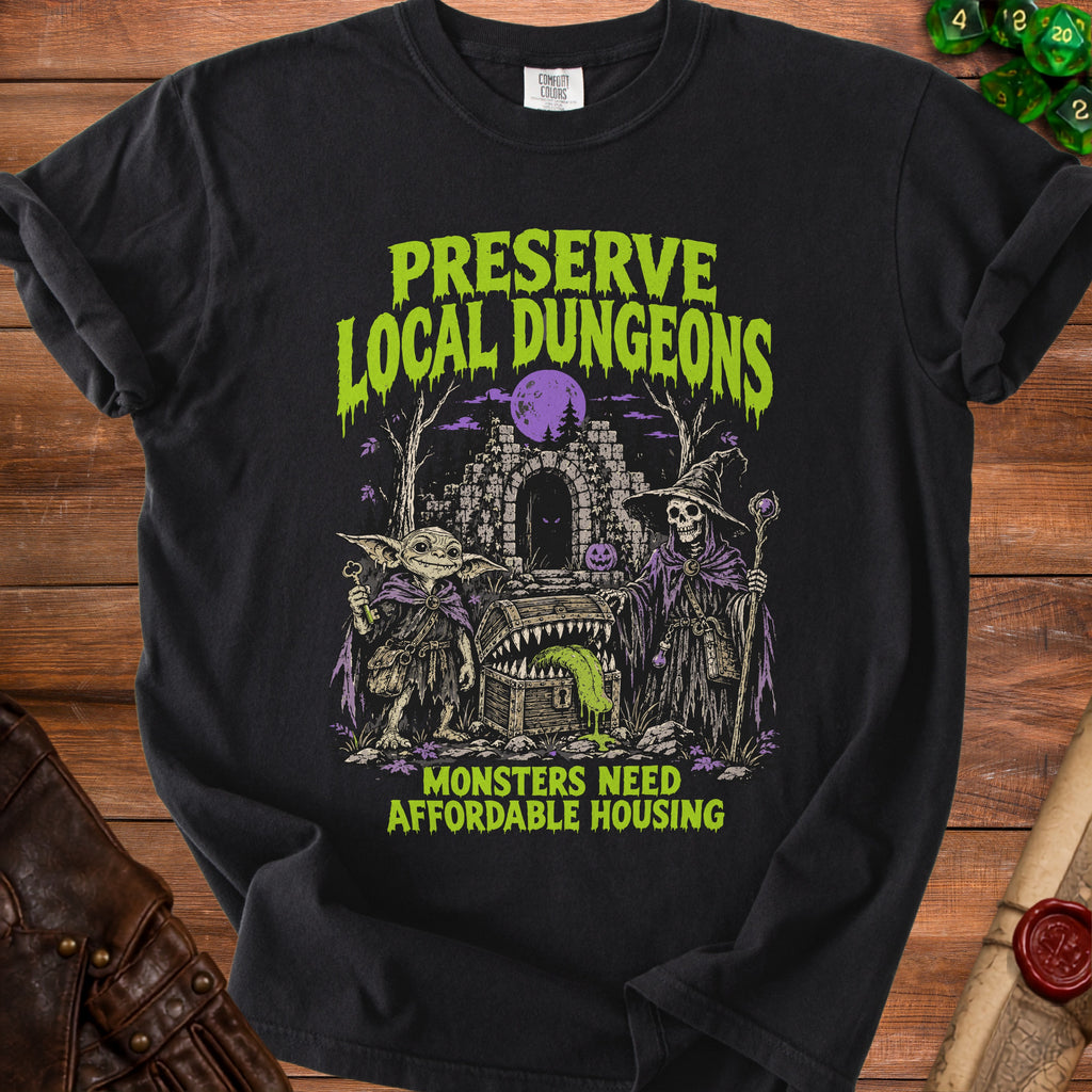 Black t-shirt with "Preserve Local Dungeons Monsters Need Affordable Housing" text and gothic monster illustration.