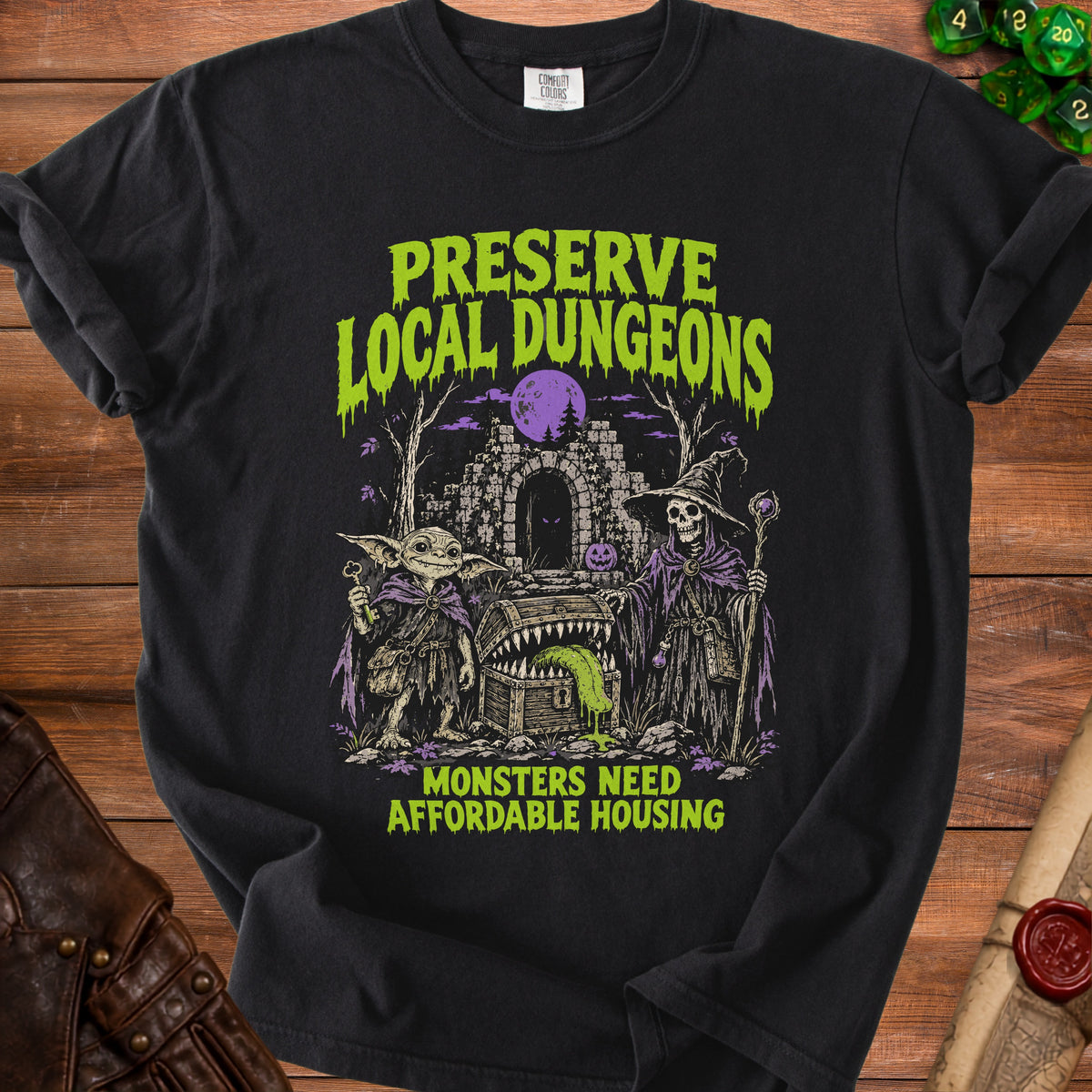 Black t-shirt with "Preserve Local Dungeons Monsters Need Affordable Housing" text and gothic monster illustration.