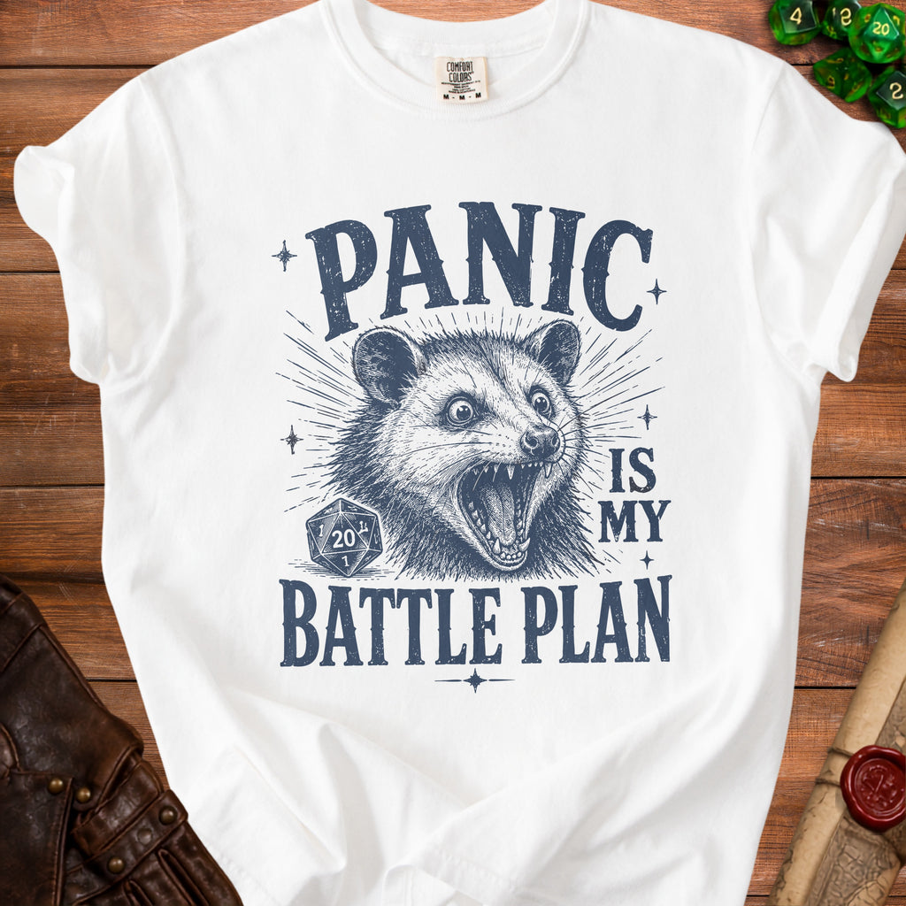 White t-shirt with distressed dark blue graphic of a possum and text "PANIC IS MY BATTLE PLAN".