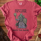 Red t-shirt with "Don't Hate The Flayer, Hate The Game" and illithid graphic.