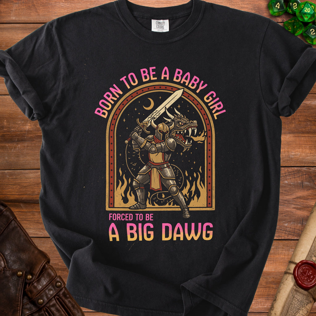 Black t-shirt graphic of a knight fighting a dragon with text "Born to be a baby girl, forced to be a big dawg."