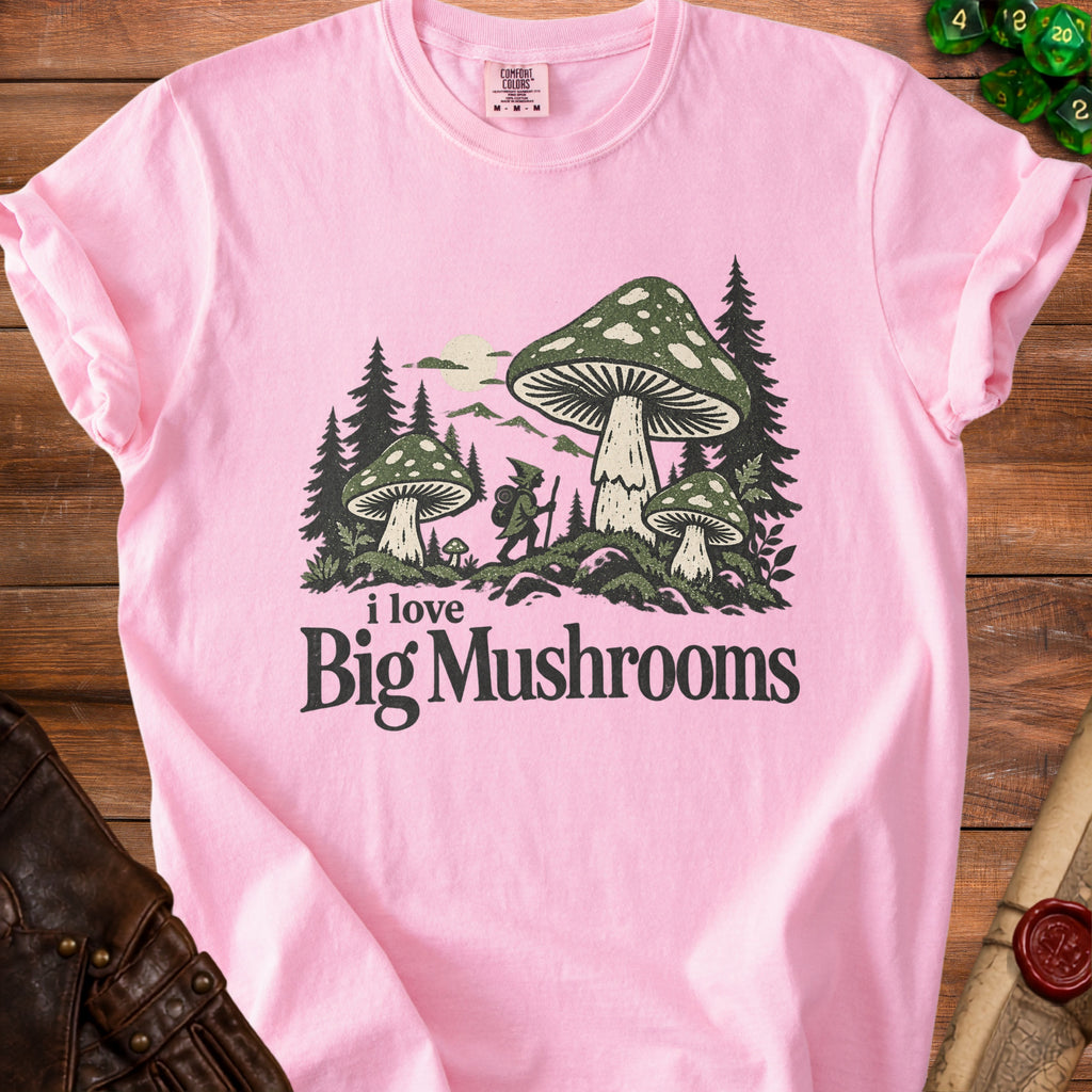 Pink t-shirt with a graphic that says "i love Big Mushrooms" and depicts mushrooms and a gnome.