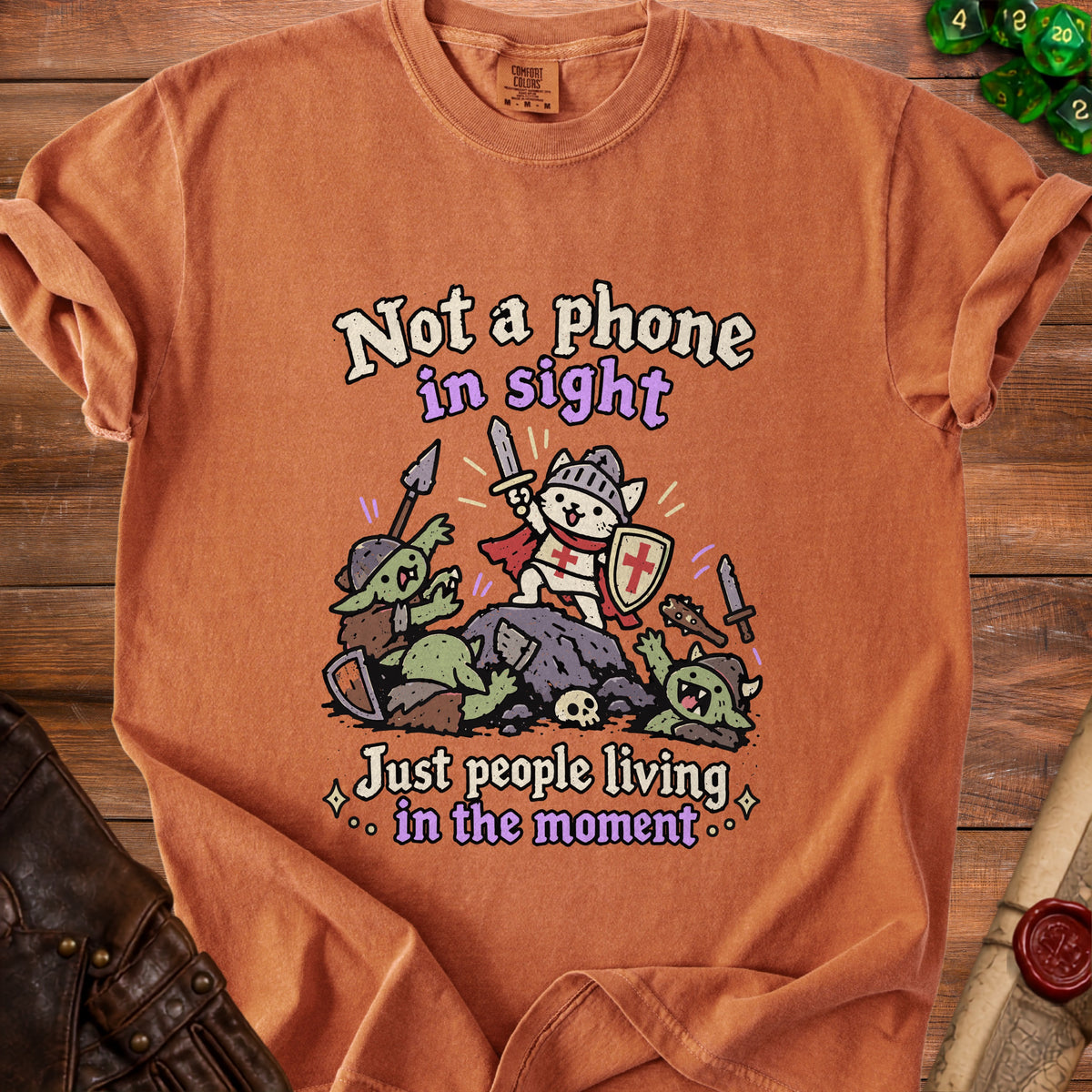 Orange t-shirt with knight cat battling goblins, text "Not a phone in sight."