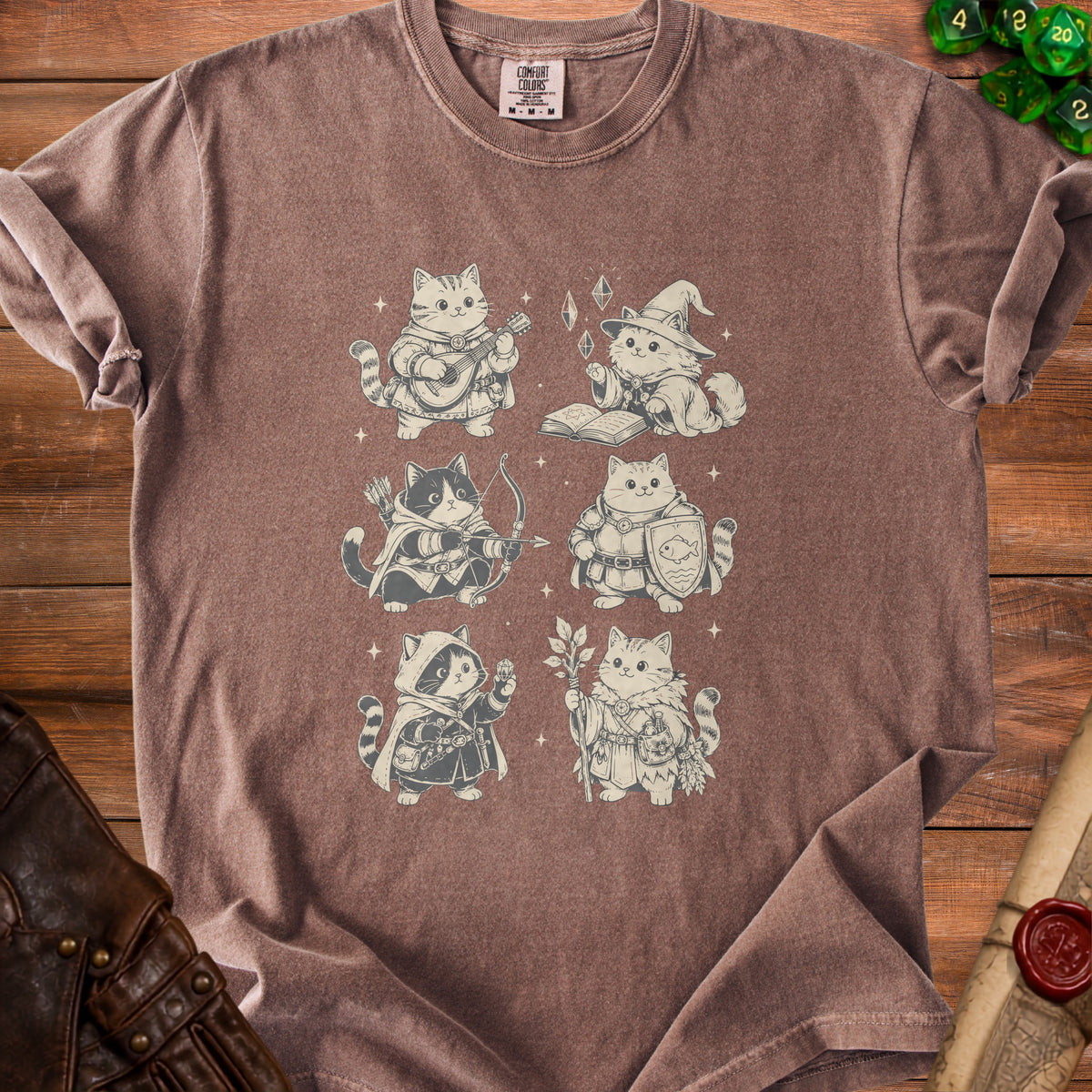 Brown t-shirt featuring six cartoon cats in fantasy adventurer outfits.
