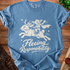 Blue t-shirt with a white graphic of a goblin riding a winged rabbit and text "Fleeing Responsibility".