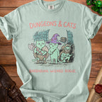 Light blue t-shirt with cartoon cats dressed as D&D characters: Barbarian, Wizard, Rogue.